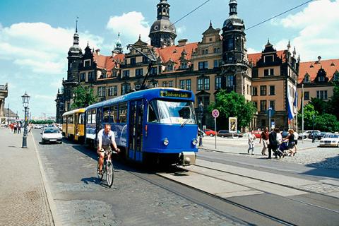 Mid adult man cycling, Royal Palace, Theater Square, Dresden, Germany