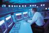 Engineer sitting at control panel of nuclear power station