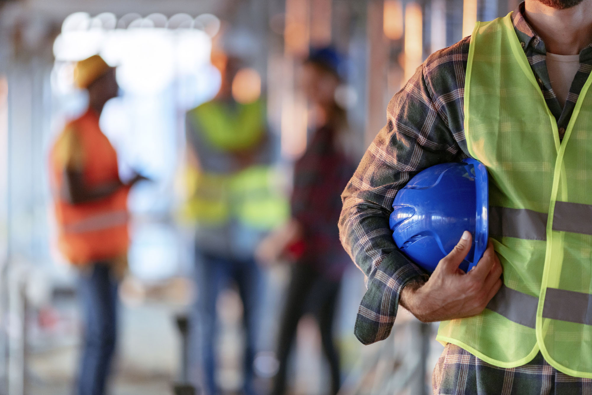Construction man worker with office and people in background