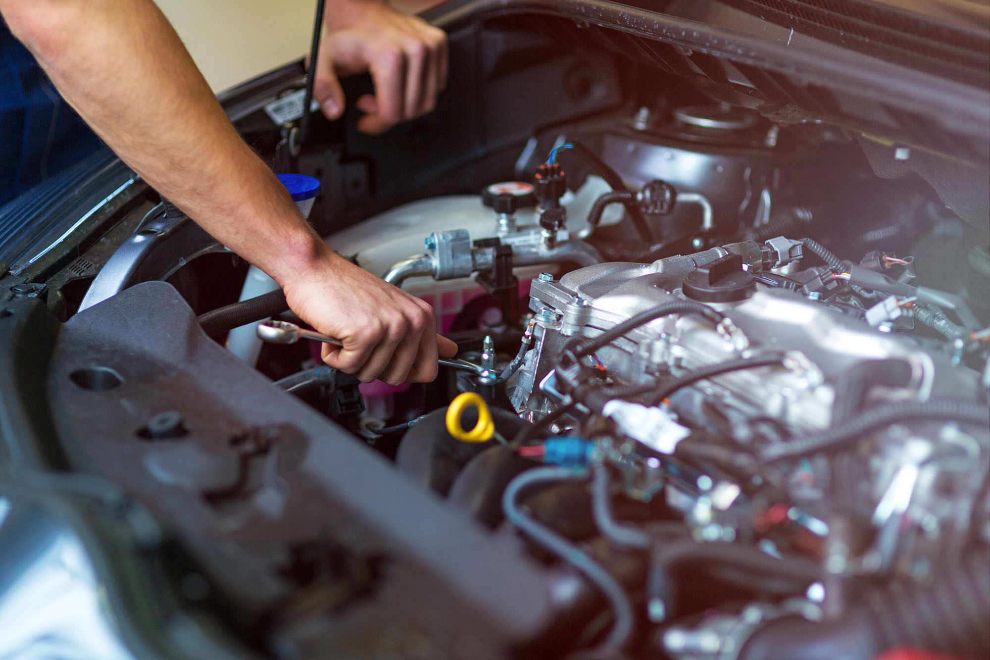 Hands of mechanic working in auto repair shop