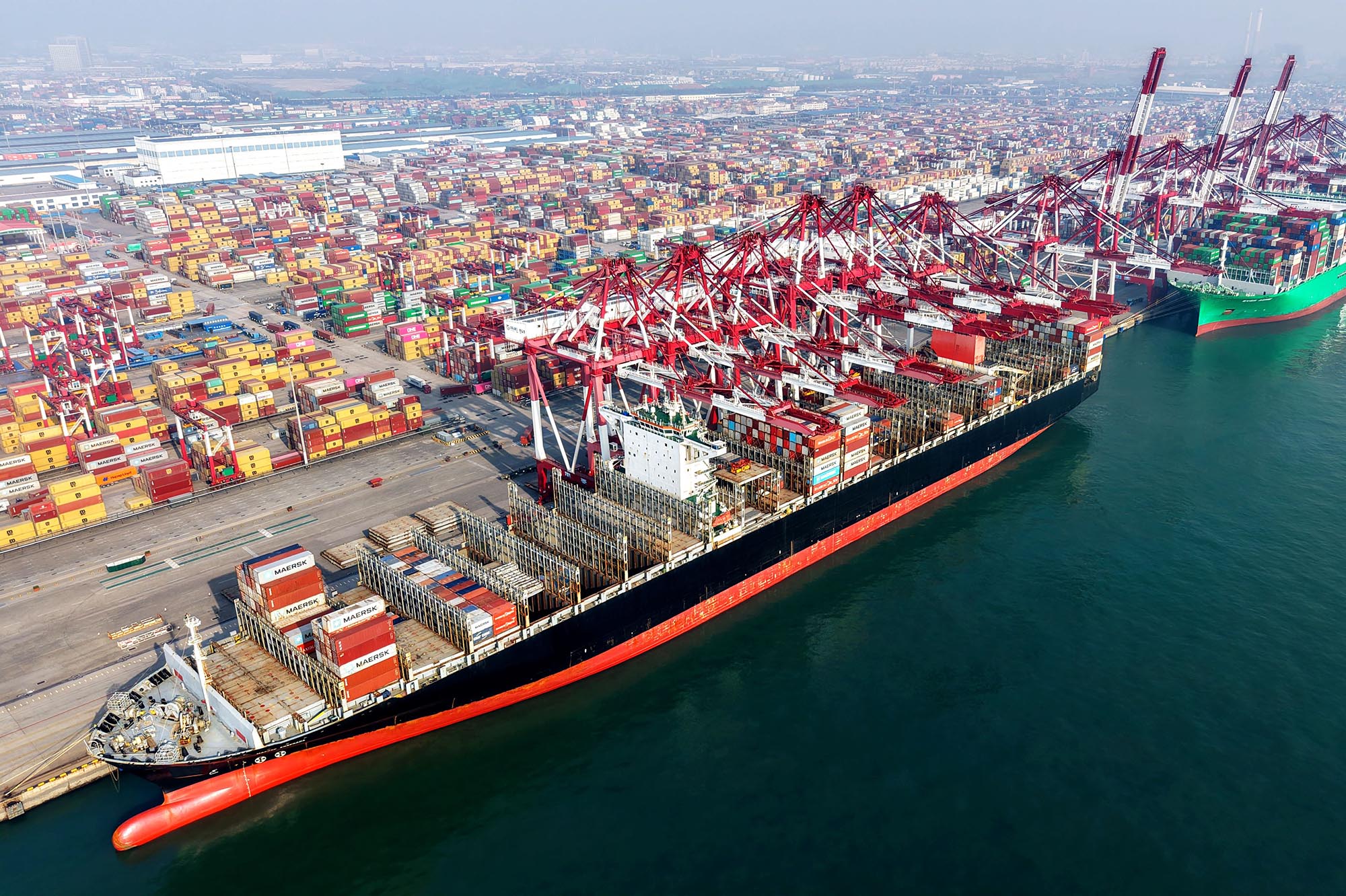 A cargo ship loads and unloads foreign trade containers at Qingdao Port in Qingdao City, Shandong Province, China