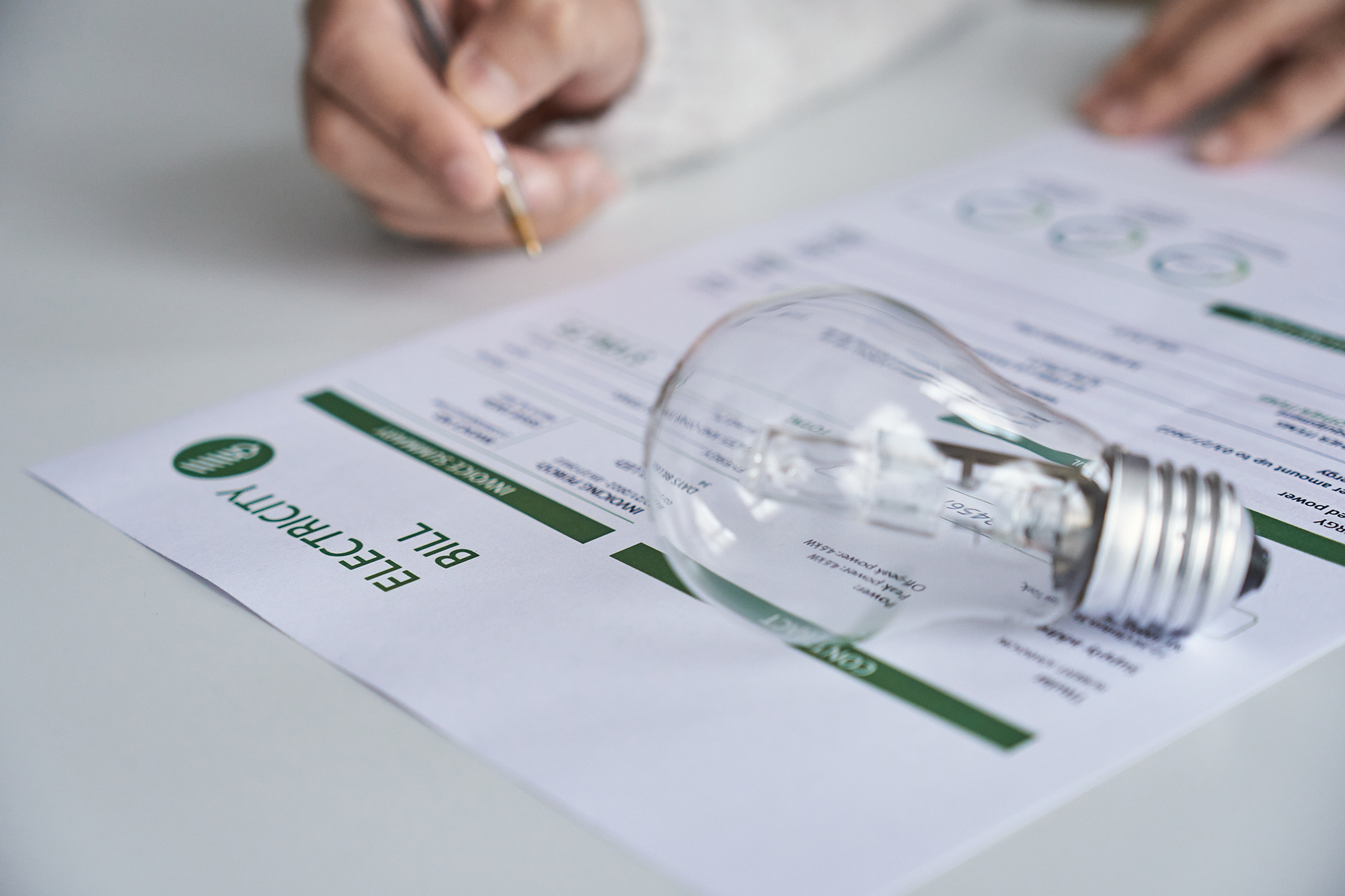 Close up view of a person checking electricity bill at home. Electricity, finance and bills concept.