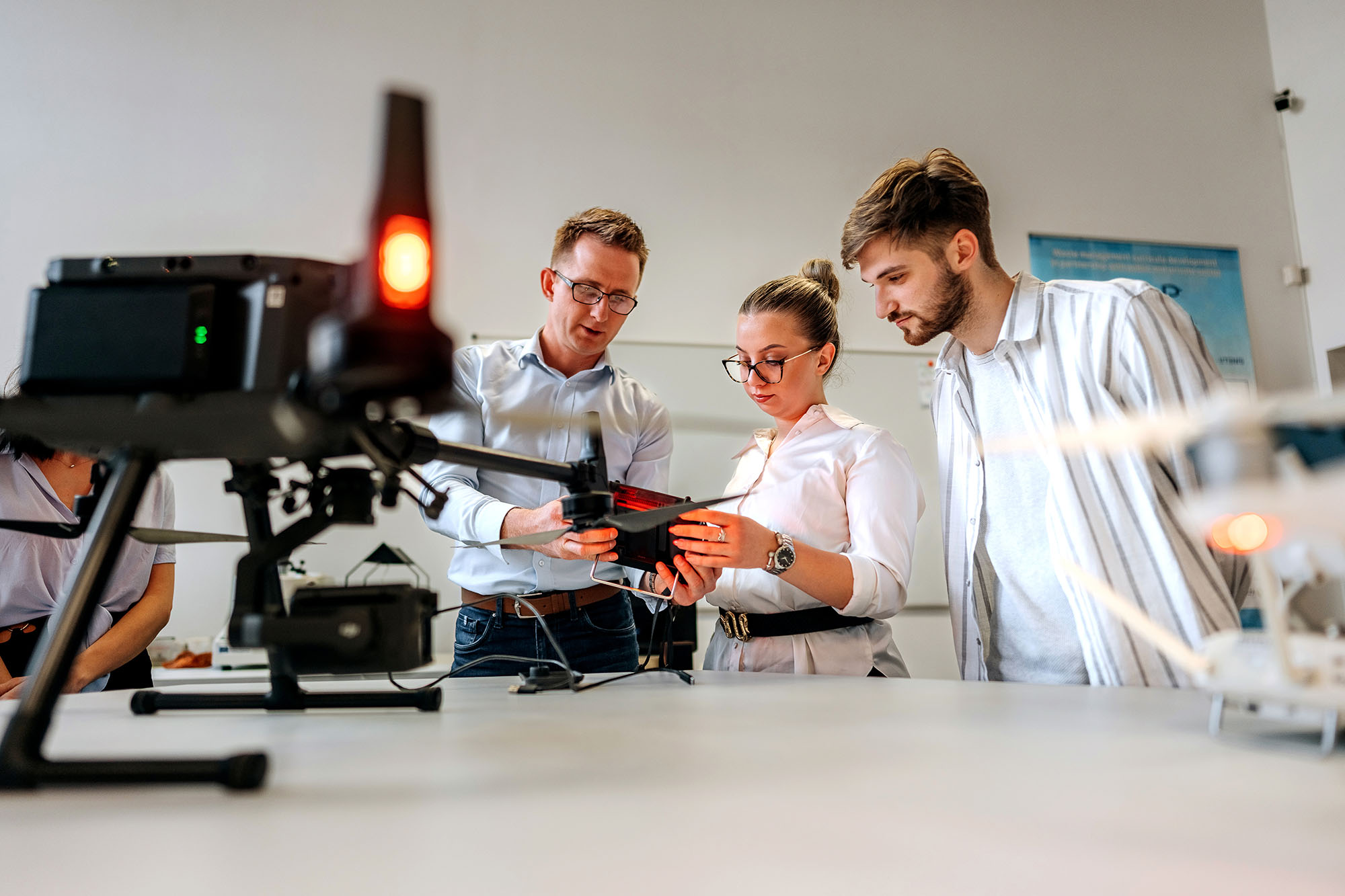 Professor talking with students about drone