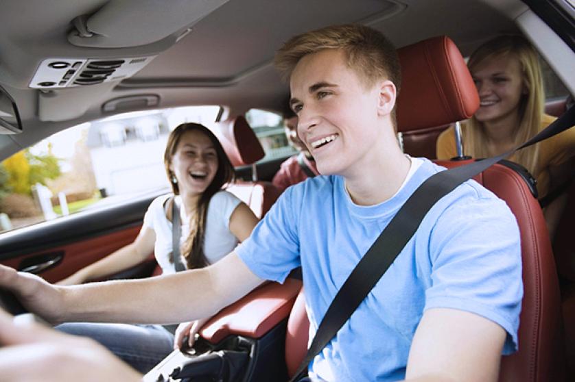 Smiling teenagers in a car