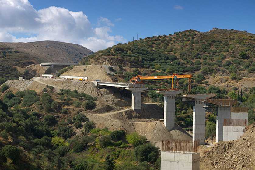 A bridge being constructed around a mountain