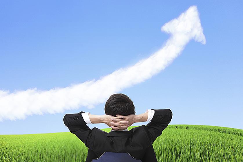business man sit on chair and watch growth cloud