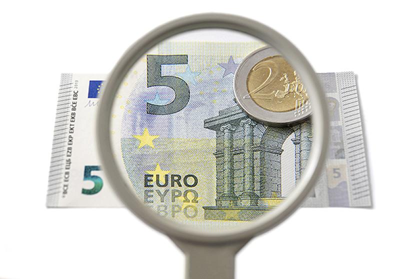 Concept of creative accounting with magnifier and money