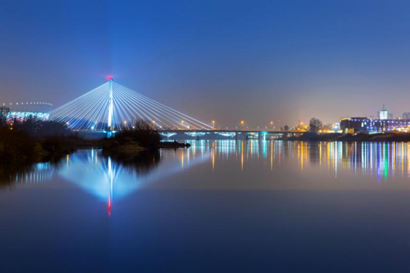Panorama of Warsaw at night with reflection in Vistula river