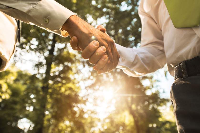 Business people shaking hands in the park