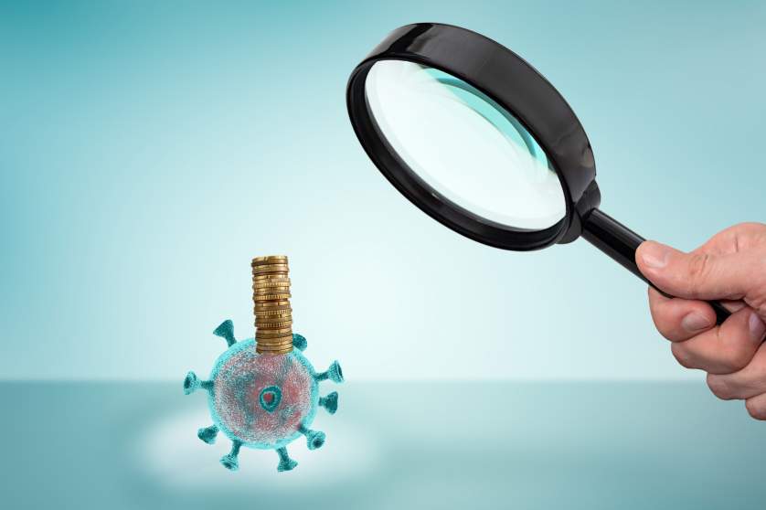 Magnifying glass over Coronavirus money