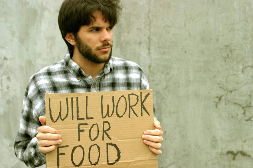 A young man holding a sign "Will work for money"