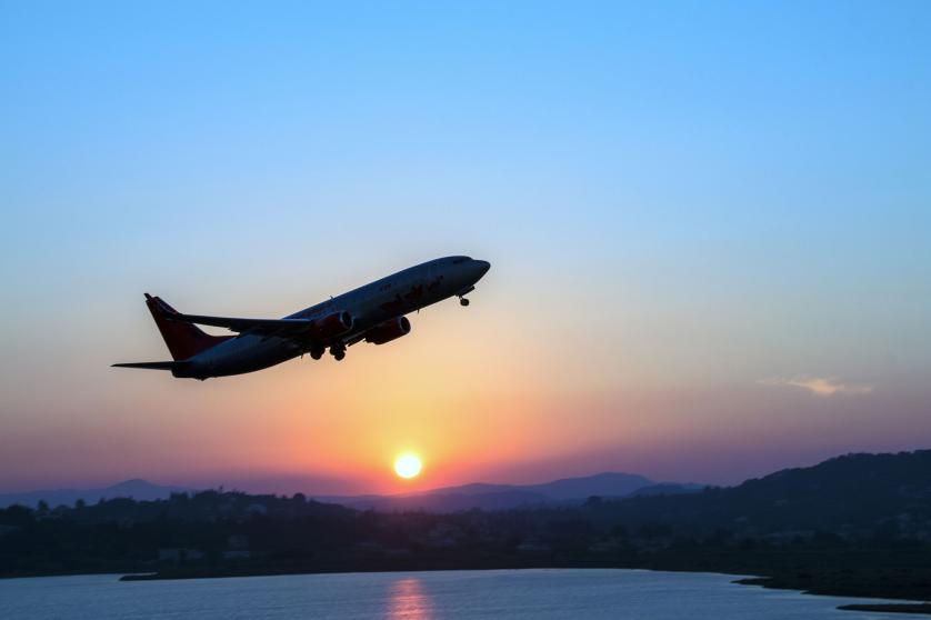 Silhouette of an airplane just after take off during sunset