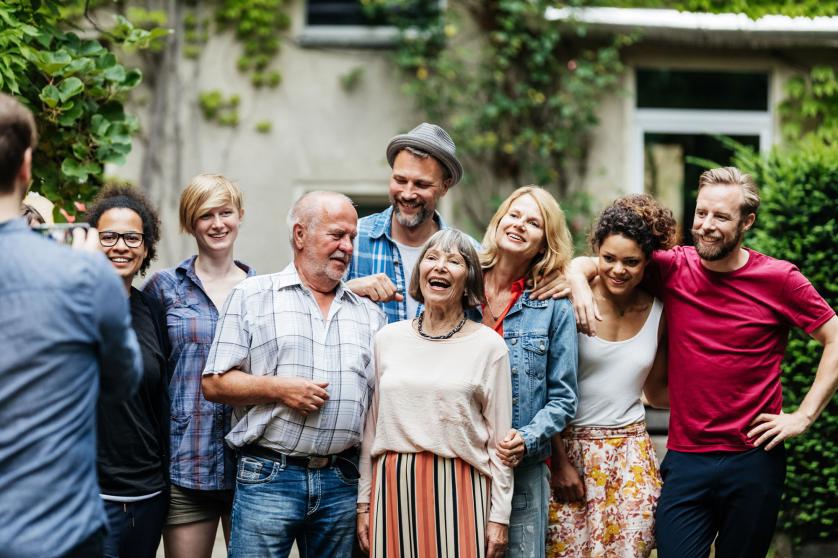 Man Taking Group Photo Of Family At BBQ