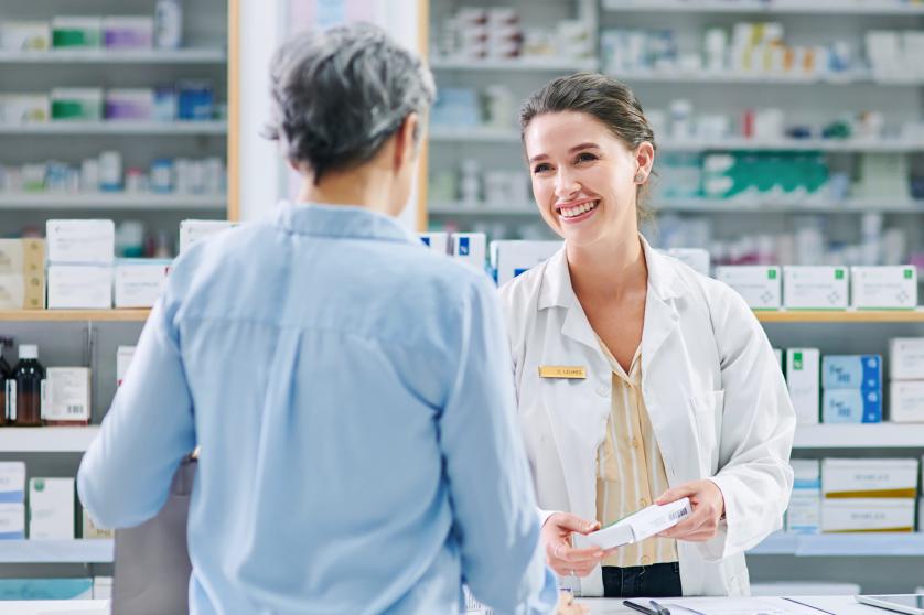 Shot of a young pharmacist assisting a mature woman in a chemist