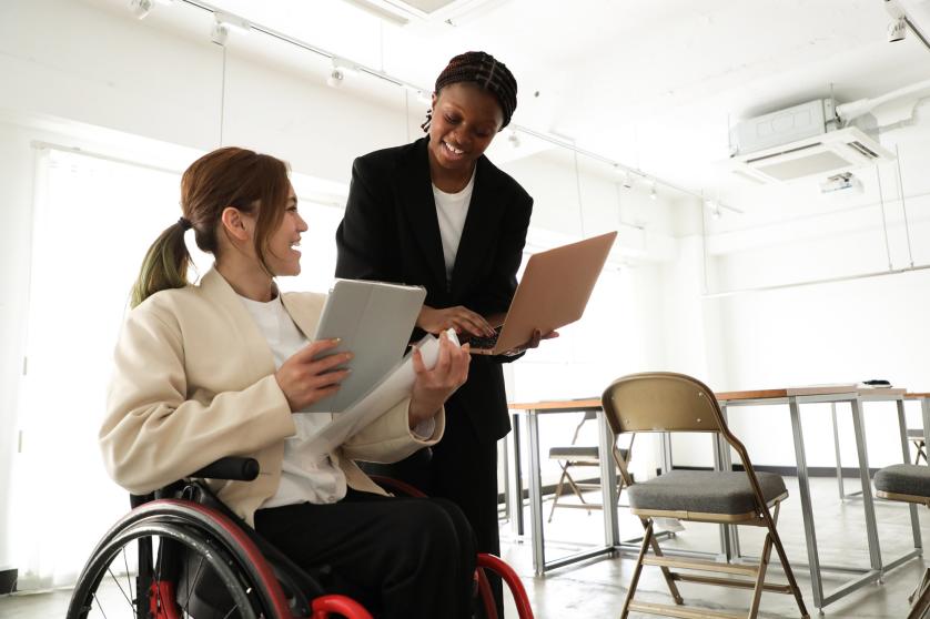 Business woman in wheelchair working in a diverse office environment
