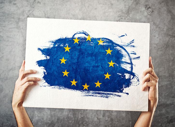 Hands holding a painting of the European flag