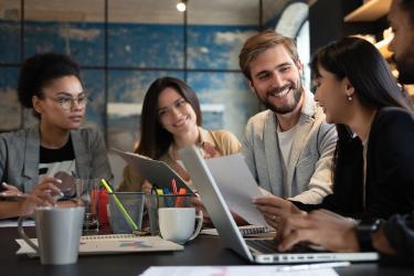 Group of young multiracial people working in modern office. Businessmen at work during meeting.