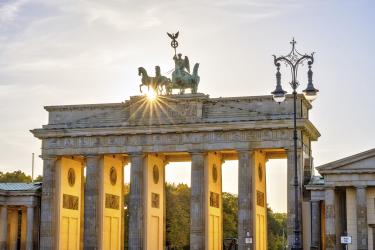 The famous Brandenburg Tor in Berlin with the last rays of sunshine in front of sunset