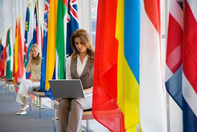 Women with laptop and international flags