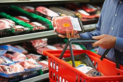 Shopper Selecting Package of Ground Beef