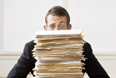 Businessman Behind Stack of File Folders