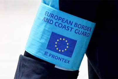 Photo of the arm of a member of the European Border and Coast Guard with the Logo of Frontex