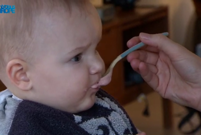 A woman feeding a baby