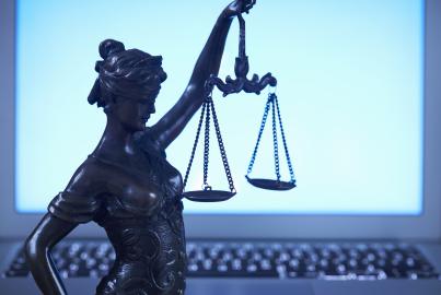 Lady Justice against laptop monitor