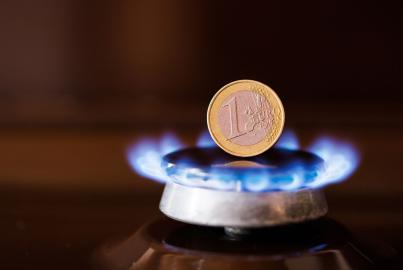 Gas stove burner with one euro coin standing vertically on top