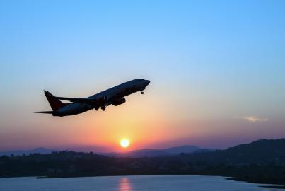 Silhouette of an airplane just after take off during sunset