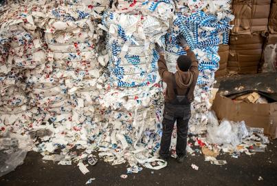 Na fábrica de reciclagem, um trabalhador sênior irreconhecível trabalha