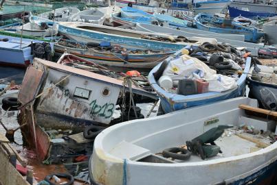 Boats used by migrants to cross the Mediterranean sea are abandoned on the beaches of Lampedusa, a small island south of Sicily