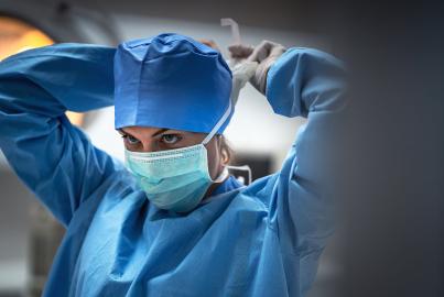 a female medical professional putting a mask on