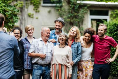 Man Taking Group Photo Of Family At BBQ