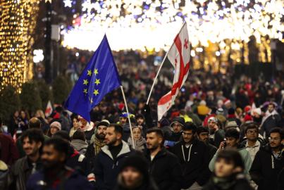 Anti-government demonstrators protest against the Georgian government's postponement of European Union accession talks until 2028, outside the parliament in central Tbilisi on December 31, 2024, the New Year's Eve.