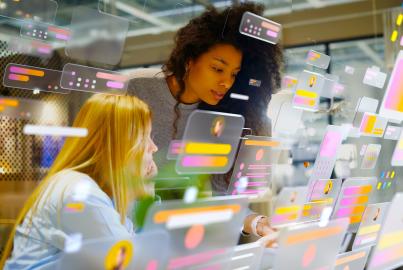Portraits of young women working in modern office surrounded by multicoloured social media icons and data screens
