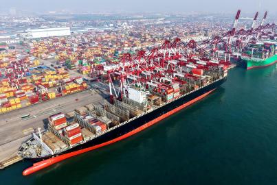 A cargo ship loads and unloads foreign trade containers at Qingdao Port in Qingdao City, Shandong Province, China