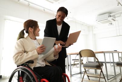 Business woman in wheelchair working in a diverse office environment