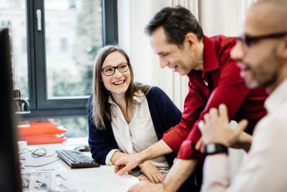 Businesswoman smiling at colleague in office