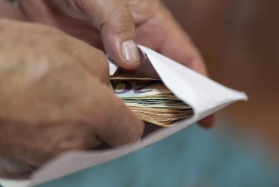 Putting money in an envelope