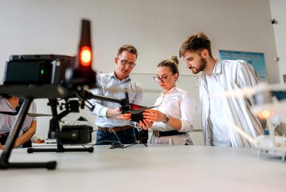 Professor talking with students about drone