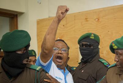 Tanzania's main opposition leader Tundu Lissu (2nd L) gestures as he enters the court room at Kisutu magistrate's court in Dar es Salaam on May 19, 2025